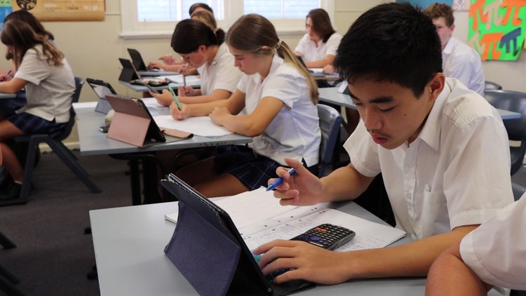 class doing math work on ipad