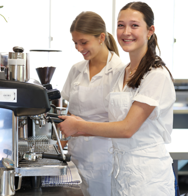 2 girls making coffee
